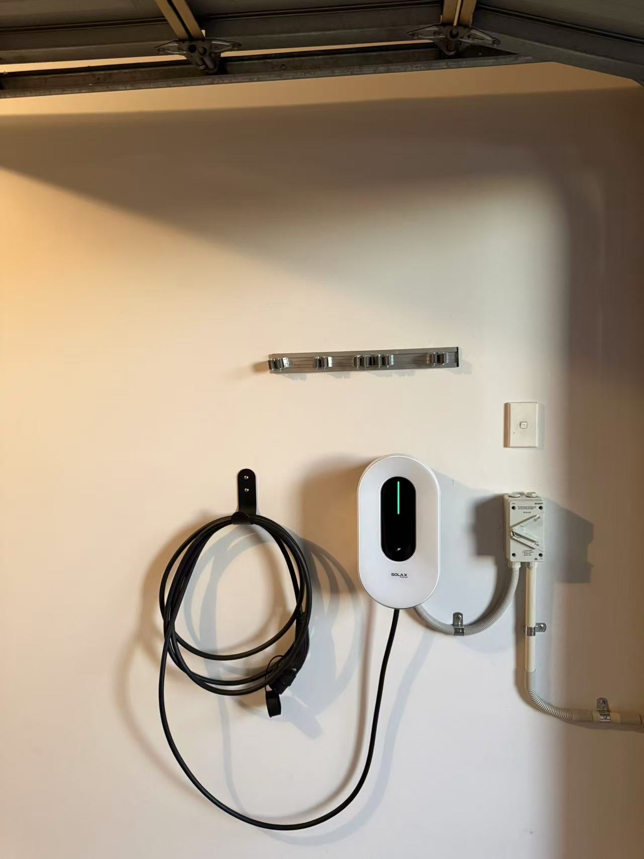 SolaX wall-mounted EV charger with cable management and isolation equipment